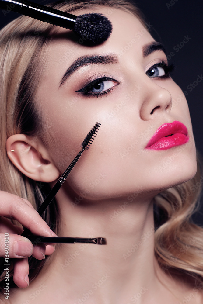 gorgeous young woman with blond hair, making make up gorgeous young woman with blond hair, making make up