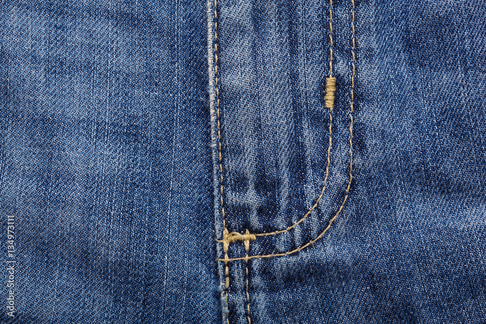 Denim jeans texture background with torn. The texture of the colored cotton fabric. Stitched texture jeans background. Fashion jeans button. Pocket and rivet on jeans. Fiber and fabric structure. Denim jeans texture background with torn. The texture of the colored cotton fabric. Stitched texture jeans background. Fashion jeans button. Pocket and rivet on jeans. Fiber and fabric structure.