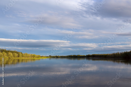 Canvas Print The coastline to the wood between the sky and the river