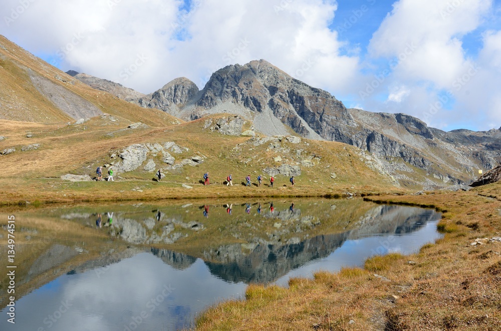 Group of people doing trekking near Lake Palasina, Aosta Valley, Italy