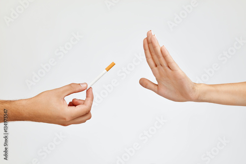 Closeup Of Beautiful Woman Hand Refusing To Take Cigarette photo