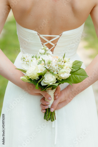the bride holding a bouquet. wedding flowers. soft focus.