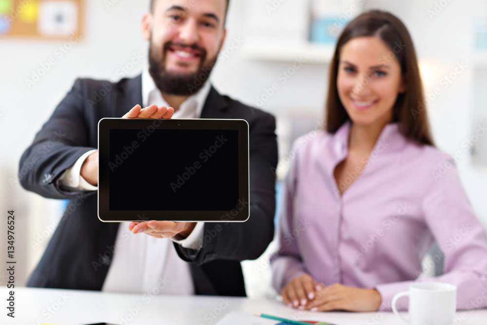 Businesspeople using tablet in office Businesspeople using tablet in office