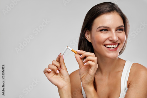 фотографія Quit Smoking. Beautiful Happy Woman Holding Broken Cigarette