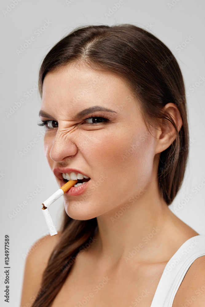 Portrait Of Girl With Cigarette In Mouth And Grimace On Face Portrait Of Girl With Cigarette In Mouth And Grimace On Face