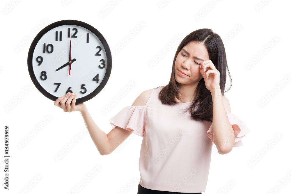 Sleepy young Asian business woman with a clock in the morning. Sleepy young Asian business woman with a clock in the morning.