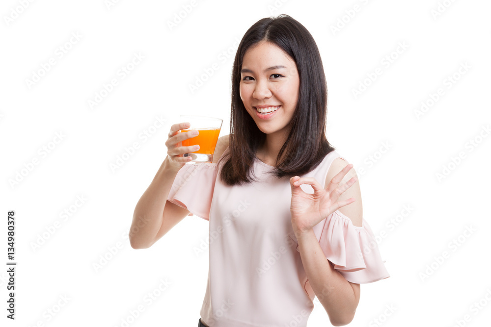Young Asian woman drink orange juice show OK sign. Young Asian woman drink orange juice show OK sign.
