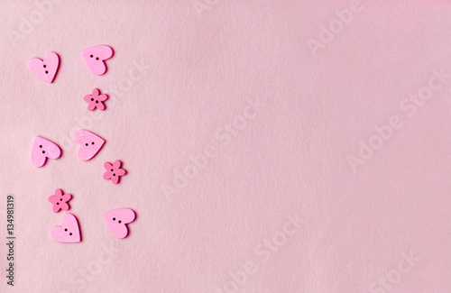 Decorations hearts and flowers on pink felt background