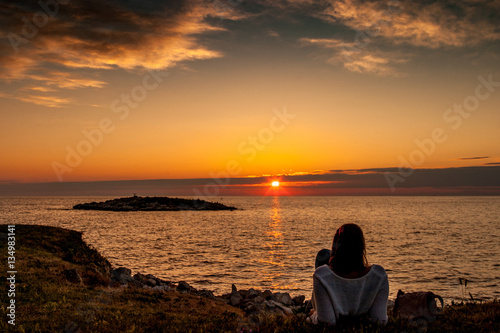 Silhouette of girl watching sunset