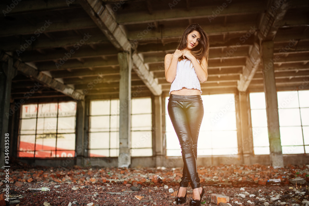 Portrait of young cute brunette girl wearing on black leather pa Portrait of young cute brunette girl wearing on black leather pa
