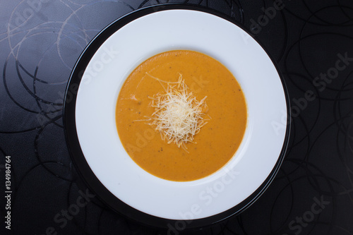 yellow soup with grated cheese