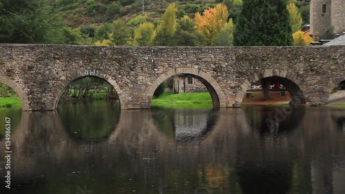 Arcos de Puente de Piedra medieval en el Rio. Reflejos del puente en el agua. Localidad de Molinaseca. El Bierzo, Provincia de Leon. España. photo