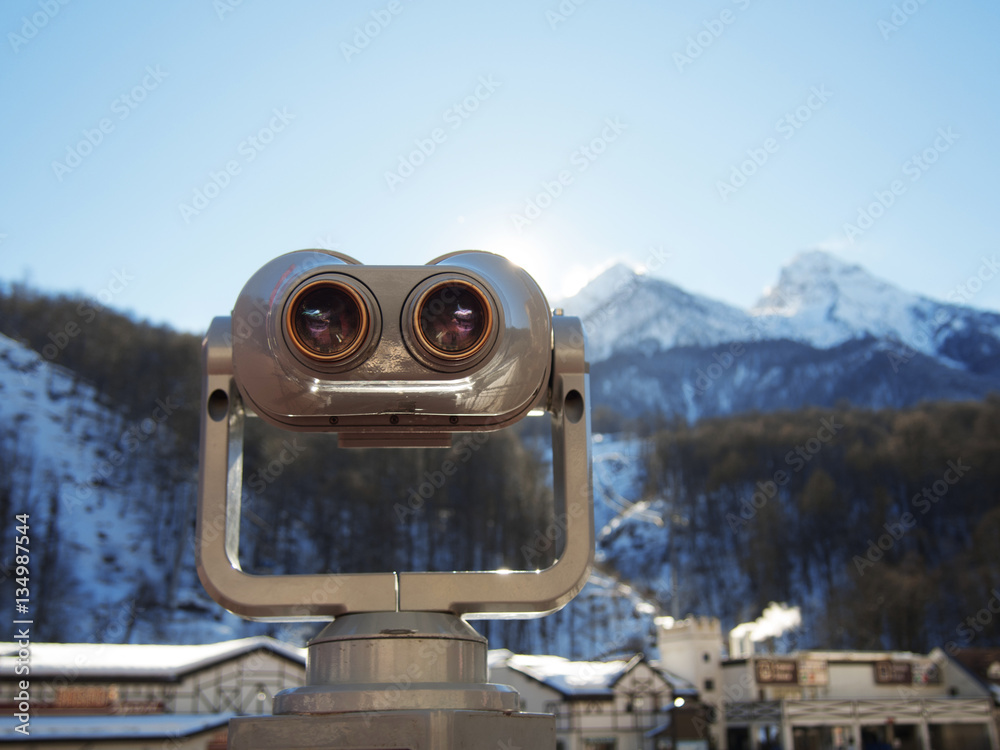 Coin operated binoculars on ski resort. Look at the top of the mountain