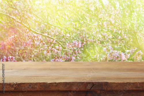 wooden table in front of spring cherry tree