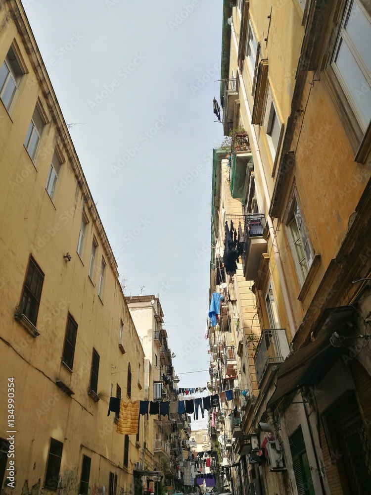 NAPLES, ITALY - JANUARY 28, 2017 : street view of old city center of Naples with clothes hanged in the street.