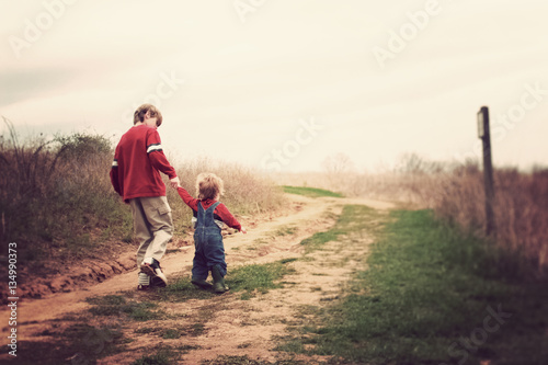 Two brothers walking up a hill photo