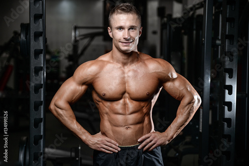 Handsome fitness model train in the gym gain muscle