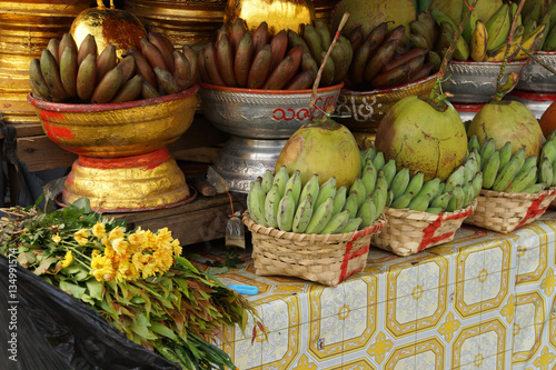 Baskets of green bananas and coconuts photo