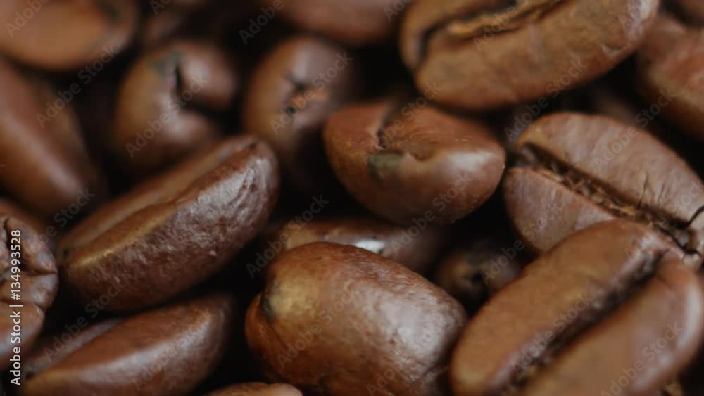 Roasted coffee beans on a table. Rotating. Close up, macro Roasted coffee beans on a table. Rotating. Close up, macro