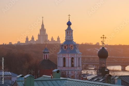 Moscow, View of the Moscow State University, domes of churches and bell towers of St. Andrew's Monastery in the background of a spring sunset