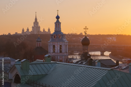 Moscow, View of the Moscow State University, domes of churches and bell towers of St. Andrew's Monastery in the background of a spring sunset