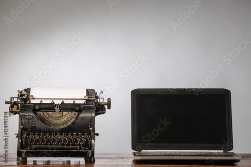 Vintage typewriter and laptop. New and old typing machines.