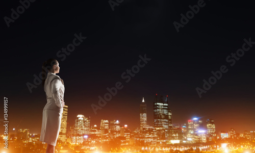 Woman looking at night city