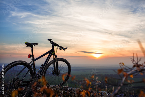 Bicycle silhouettes with sky on sunsets time. © Aleksey
