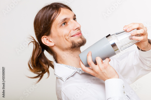 Long haired barman shaking head.