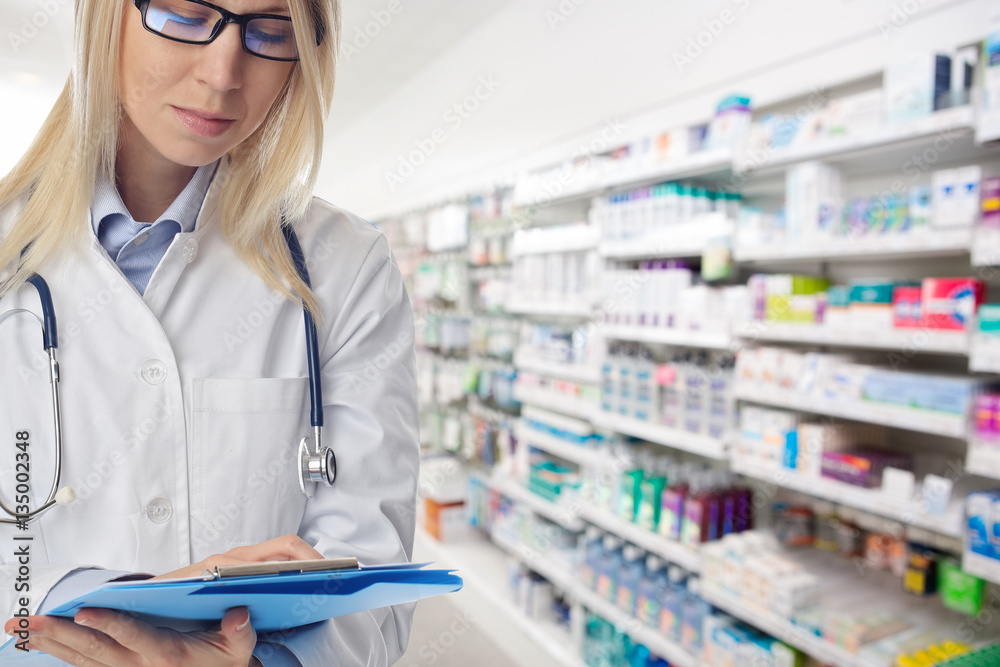 Portrait of smiling female pharmacist in pharmacy drugstore