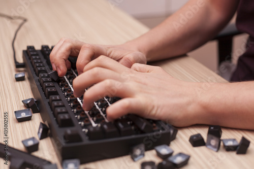 Man breaks a mechanical computer keyboard by typing angrily