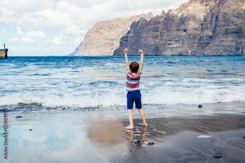 Happy child playing on beach. photo