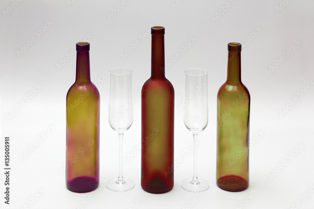 empty bottles and wine glasses on a white background empty bottles and wine glasses on a white background