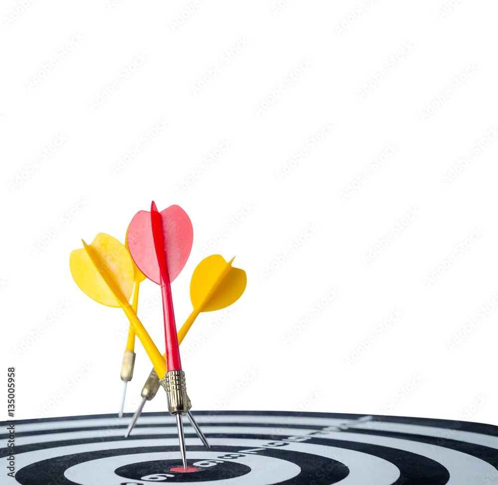 Close up shot red dart arrow on center of dartboard and yellow a Close up shot red dart arrow on center of dartboard and yellow a