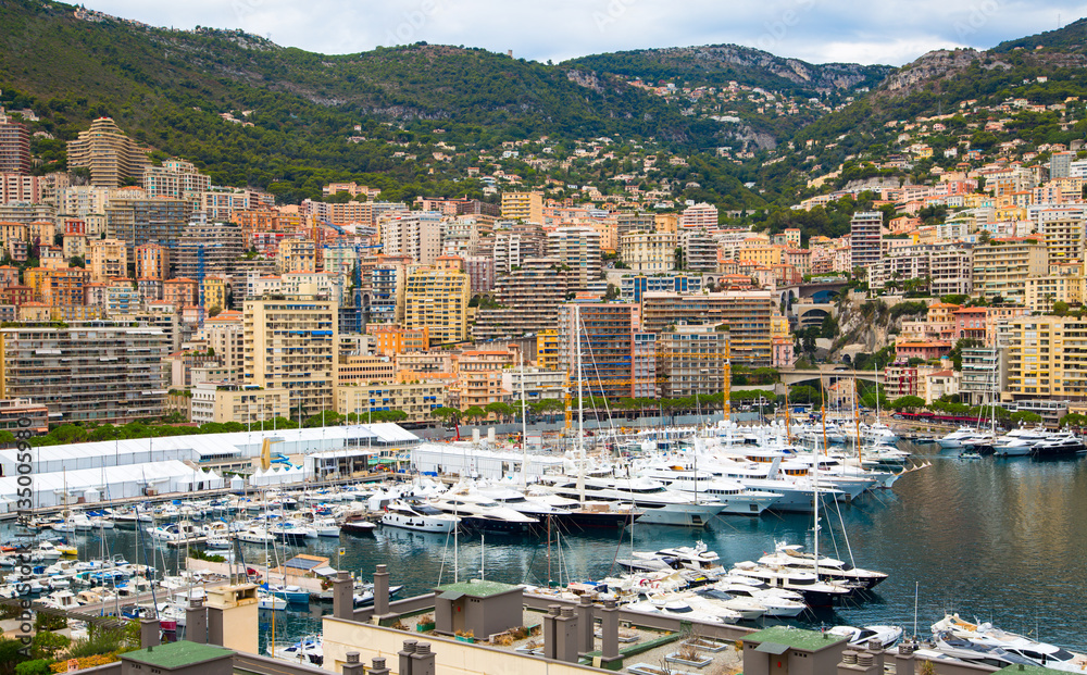 Principality of Monaco. View of the seaport and the city of Monte Carlo with luxury yachts and sail boats 
