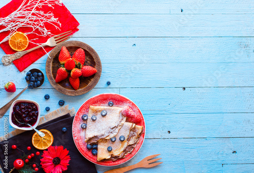 Fresh Strawberries Pancakes or Crepes with berries and chocolate