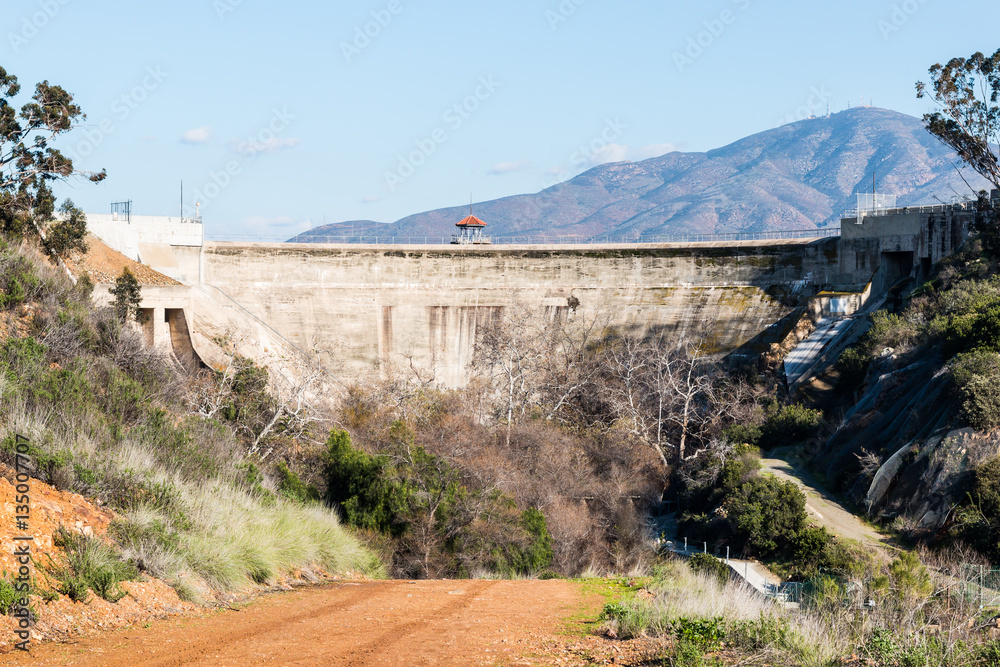 Close-up view of Sweetwater dam with road and San Miguel Mountain in the background in San Diego, California.