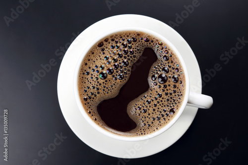 white cup of hot black coffee on dark background © photosaint