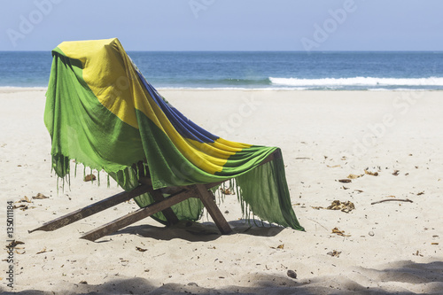 Ilhabela, Brazil, Chair covered with brazilian flag on the beach © AnaClaraTito