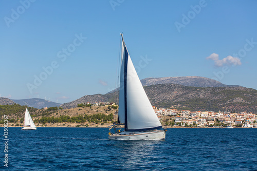 Luxury yachts in the regatta. Racing on a boats in the wind on the waves of the sea..