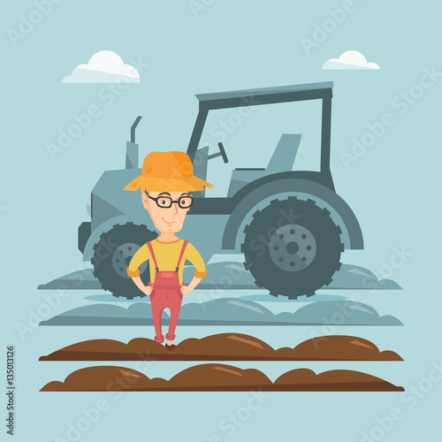 Farmer standing with tractor on background.