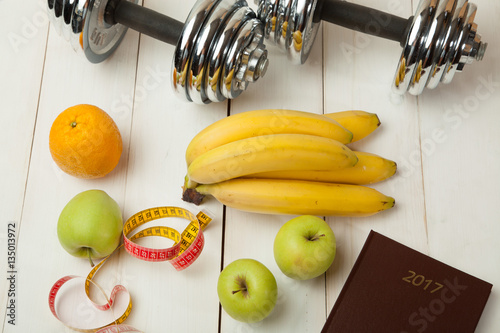 diet plan, menu or program, weight loss, measuring tape, dumbbells and dietary food fresh fruit