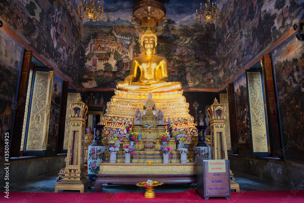 The altar with the sculpture of a seated Buddha in the bot of Wat Wihan Bovornniwet. Bangkok, Thailand