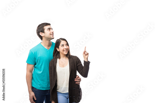 Cute couple looking and pointing up