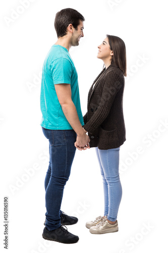 Cute couple holding hands in a studio