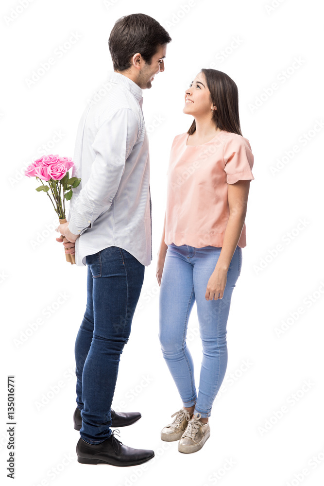 Man surprising girlfriend with flowers