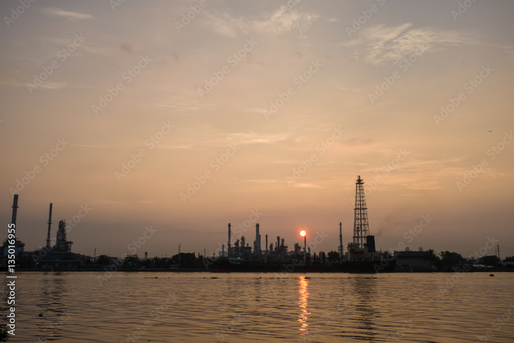 Oil refinery construction plant sunrise with river