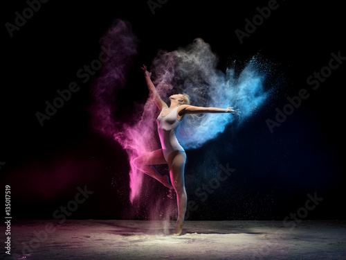 Woman in color dust cloud streches up gracefully © Wisky