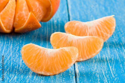 tangerine slices on a blue wooden background
