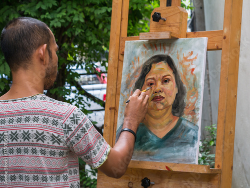 Artist painting portrait of asian woman,oil color on canvas